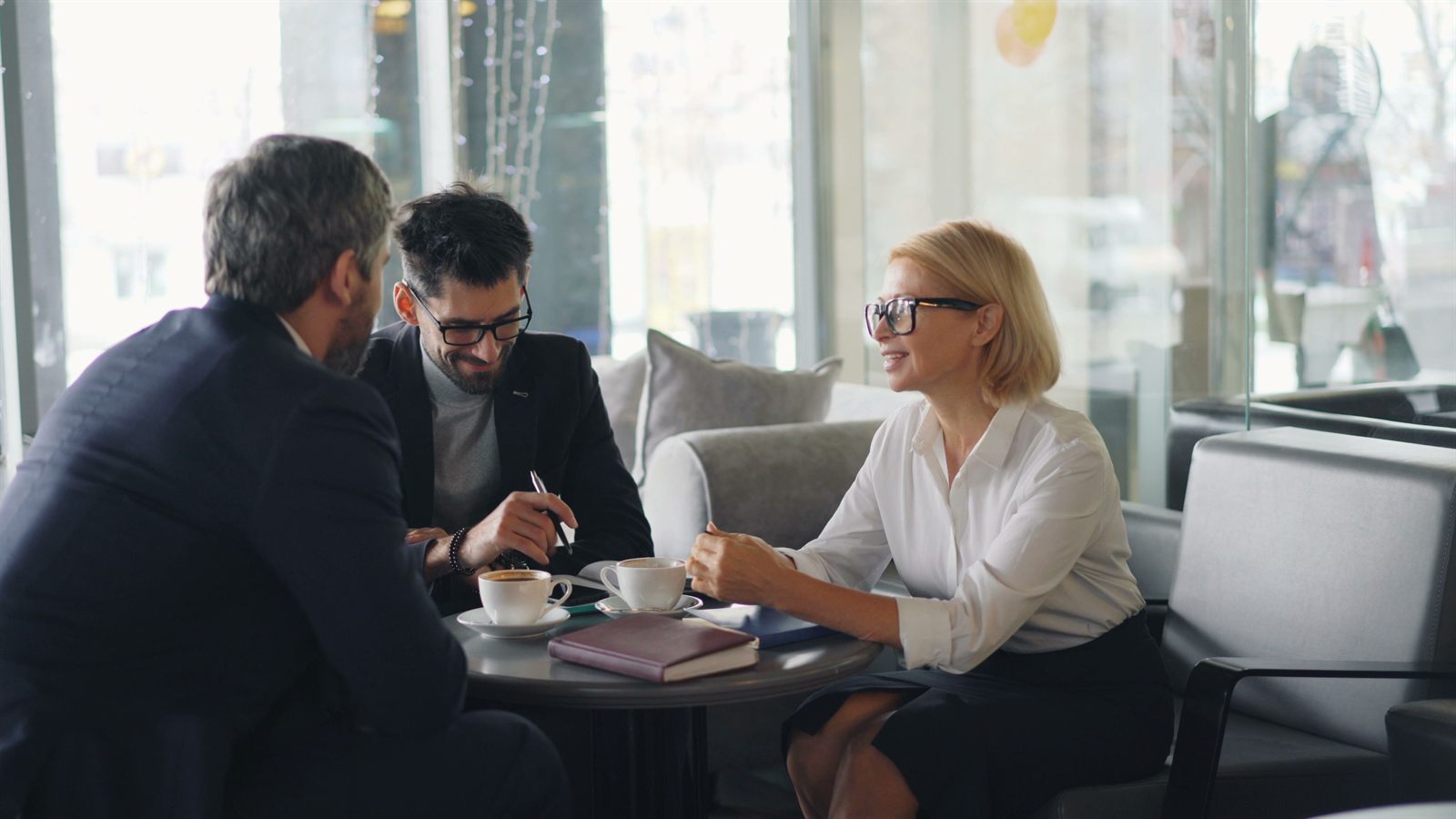 Business owners meeting with a Beacon advisor over coffee